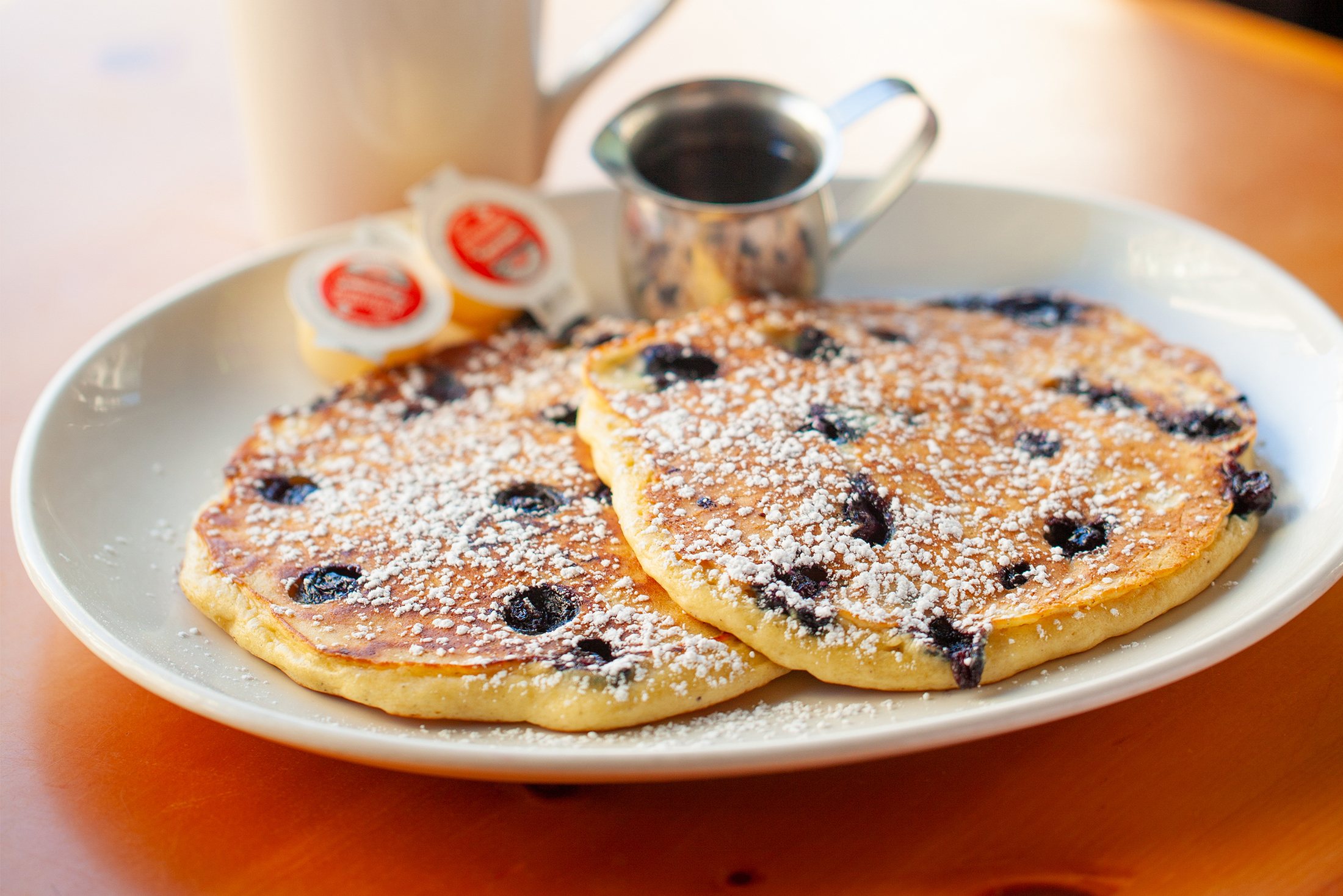 Blueberry pancakes with butter and maple syrup